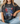 Person wearing a black t-shirt with patriotic design and text.