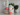 Two insulated tumblers with floral designs on a decorative surface.