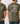 Olive green t-shirt with fish graphic and text on a white wooden background