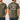 Olive green t-shirt with fish graphic and text on a white wooden background