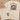 Beige t-shirt with fish graphic and text on a wooden surface