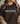 Person wearing a brown t-shirt with 'This is God's Country' text, Psalm 50:11, against a neutral background.