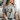 Person wearing a gray t-shirt with 'Jesus was all along' text design.