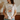 Person wearing a t-shirt with floral design and text, holding a mug.