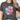 Person wearing a dark gray t-shirt with a smiley face design featuring American flag and flowers.