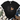 A black short-sleeve T-shirt laid flat with a leopard-print apple graphic and a tan heart shape on the front. The shirt is styled in a flat-lay arrangement with blue jeans, brown shoes, a cream throw blanket, and greenery on a white wood background.