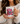 Person holding a mug with a design of a pink armchair and text 'My weekend is all booked'.