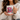 Person holding a mug with a design of a pink armchair and text 'My weekend is all booked'.