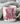 Mug with a pink armchair and book design, text 'My weekend is all booked', surrounded by cozy blankets.