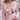 A woman wearing a light pink crewneck sweatshirt with a graphic of nine cute, patterned chickens on the front, set against an outdoor background.