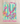 A beige canvas tote bag with brown shoulder straps, featuring a colorful graphic of a stethoscope and flowers on a striped background, with the text 'Created with Purpose' printed below. The bag is displayed on a wooden surface against a white wall with decorative plants in the background.