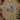 A tan crewneck t-shirt with a detailed graphic of three deer in a pine forest, laid flat on a rustic wooden background surrounded by hunting-themed props like a hat, binoculars, and boots.