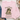 A folded light pink sweatshirt laid flat on a white wood surface, featuring a graphic of a frog wearing sunglasses and holding a coffee mug, with the text 'First Of All, Jesus Thinks I'm A Delight'.