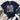 A navy blue graphic t-shirt laid flat on a light wood background, styled with a cream throw blanket, greenery, blue jeans, and white sneakers. The t-shirt features a colorful cartoon owl and the text 'DOING MY BEST LETTING GOD DO THE REST'.