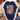 A navy blue graphic T-shirt with the phrase 'LOVE LIKE DOLLY' in colorful patchwork-style letters and butterflies, styled in a flat lay with a cream knit cardigan, jeans, boots, and holiday greenery.