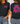 A woman modeling a black graphic T-shirt shown from both front and back. The front has a small pink and white 'ESTHER four fourteen' graphic on the left chest.