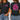A woman modeling a black graphic T-shirt shown from both front and back. The front has a small pink and white 'ESTHER four fourteen' graphic on the left chest.