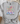 Gray t-shirt with colorful mountain and cross design on a white surface