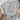 Gray t-shirt with colorful mountain and cross design on a white surface