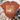 A rust-orange graphic t-shirt featuring a white goose wearing a plaid bow and heart-shaped sunglasses while holding an iced coffee, styled in a flat-lay with jeans, a knit blanket, and boots on a white wood background.