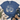 A blue short-sleeve graphic T-shirt laid flat on a light wood surface, styled with jeans, tan boots, a striped throw blanket, and greenery. The shirt has a western-themed cream graphic with cactus, cowboy boots, stars, and the phrase 'find joy in the little things.