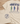Beige t-shirt with fish illustrations and Bible verse on a wooden surface