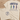 Beige t-shirt with fish illustrations and Bible verse on a wooden surface