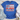 Blue t-shirt with a decorative design featuring a bow, flowers, and polka dots on a wooden surface with shorts and sneakers.