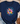 Navy blue t-shirt with a colorful flower graphic and text on a textured surface.