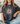 Person wearing a black t-shirt with a colorful flower design and text.