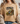 Person wearing a beige t-shirt with a graphic design and text.
