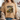 Person wearing a beige t-shirt with a graphic design and text.