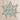 A beige canvas tote bag with brown leather handles, featuring a large star graphic on the front with the phrase 'God is good all the time' in script and patterned star details, set on a wooden surface against a white wall with eucalyptus branches.