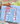 Person holding a blue towel with text and star design on a porch