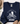 A navy blue sweatshirt with a white graphic of a frog riding a bicycle and the text 'BE HUMBLE BE KIND leave your worries BEHIND', laid flat on a white wood background with a hat, jeans, and shoes partially visible around it.