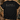 A black short-sleeve t-shirt laid flat on a rustic wood surface, featuring a hunting-themed graphic with deer, antlers, a duck hat, a duck, a dog, and the words 'HUNTING SEASON' in white. Surrounding props include camouflage boots, a cap, binoculars, and evergreen branches.