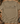 An olive green short-sleeve t-shirt laid flat on a rustic wooden surface, surrounded by hunting-themed props including a deer head, antlers, a camouflage hat, binoculars, and a boot. The shirt features a graphic of various hunting-related icons (deer head, antlers, bear skull, duck, dog) above the text 'HUNTING SEASON'.