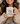 Woman holding a mug with 'Powered by Jesus & Coffee' text and design.