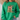 A person wearing a bright green crewneck sweatshirt with a Christmas-themed graphic on the front. The graphic features a wooden cross with a red-and-white gingham bow, a green Christmas tree, and the text 'JESUS is the SEASON for the SEASON' in red and black lettering.