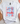 White t-shirt with 'Let Freedom Ring' design on a light surface with decorative items.