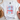 White t-shirt with 'Let Freedom Ring' design on a light surface with decorative items.