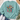 A mint green crewneck sweatshirt laid flat on a white wood background, styled with blue jeans, white sneakers, a straw hat, and eucalyptus leaves. The sweatshirt features a colorful graphic of a cross with Christmas lights and the text 'BE THE LIGHT Matthew 5:14'.