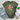 Green t-shirt with turtle and flower design, paired with jeans and sneakers on a wooden surface.