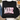 A black long-sleeve crewneck sweatshirt laid flat on a white wood surface, featuring the phrase 'MADE for more EPHESIANS 2:10' in decorative pink and floral lettering. The sweatshirt is styled with jeans, a coffee cup, a plaid blanket, and flowers around it.