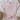 Pink t-shirt with 'MADE FROM joy' text on a white surface