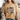 A woman wearing a tan graphic t-shirt with a 'Mountain Mover' design, styled with a chunky knit cardigan and blue jeans in a cozy indoor setting.