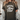 Person wearing a dark green t-shirt with 'Praying Moms Club' text.