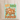 A cream canvas tote bag with brown shoulder straps stands on a wooden surface against a white wall. The front of the bag has a colorful autumn graphic with the text 'HEY THERE PUMPKIN' and an illustration of pumpkins, flowers, and leaves on a light blue background.