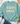 A mint green crewneck sweatshirt with a retro-style graphic reading 'SAVED BY GRACE' in cream, pink, and teal, styled in a flat lay with jeans, white sneakers, a straw hat, and eucalyptus on a white wood background.