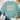 A mint green crewneck sweatshirt with a retro-style graphic reading 'SAVED BY GRACE' in cream, pink, and teal, styled in a flat lay with jeans, white sneakers, a straw hat, and eucalyptus on a white wood background.
